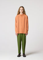 A model wears the IM MEN AIR PLEATS trousers.