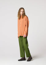 A model wears the IM MEN AIR PLEATS trousers.
