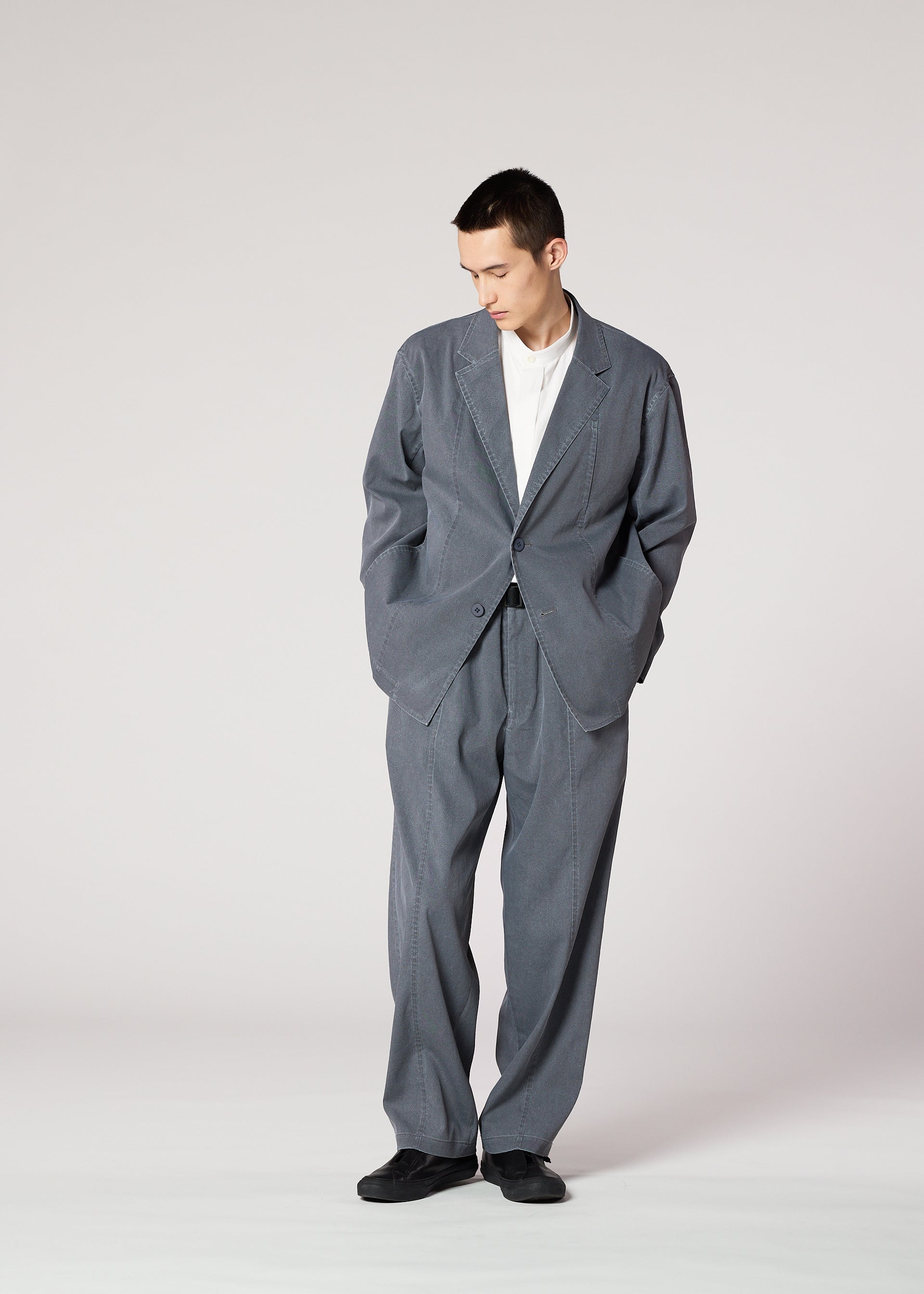 A model wears the IM MEN AIR WASH air-wash-trousers-grey.
