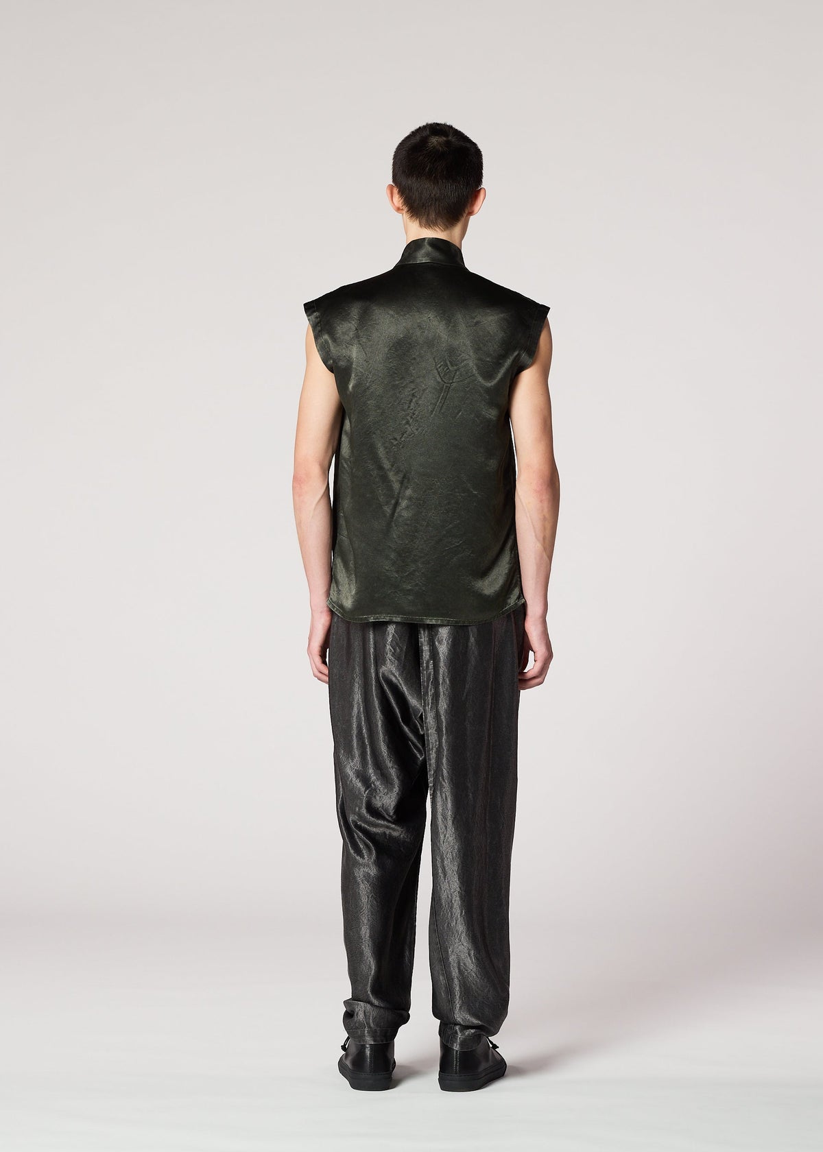 A model wears the IM MEN SATIN WASH trousers.
