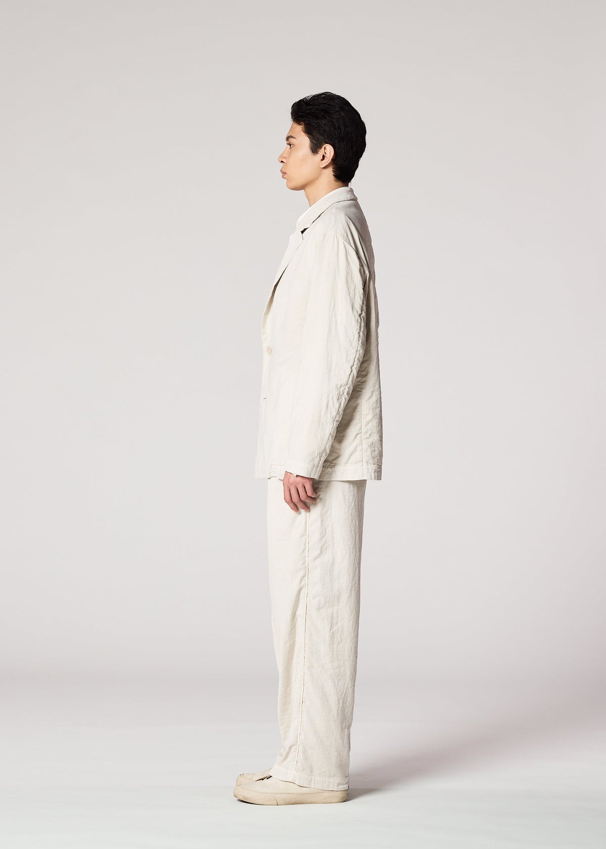 A model wears the IM MEN PIGMENT DOUBLE FACE COTTON trousers.