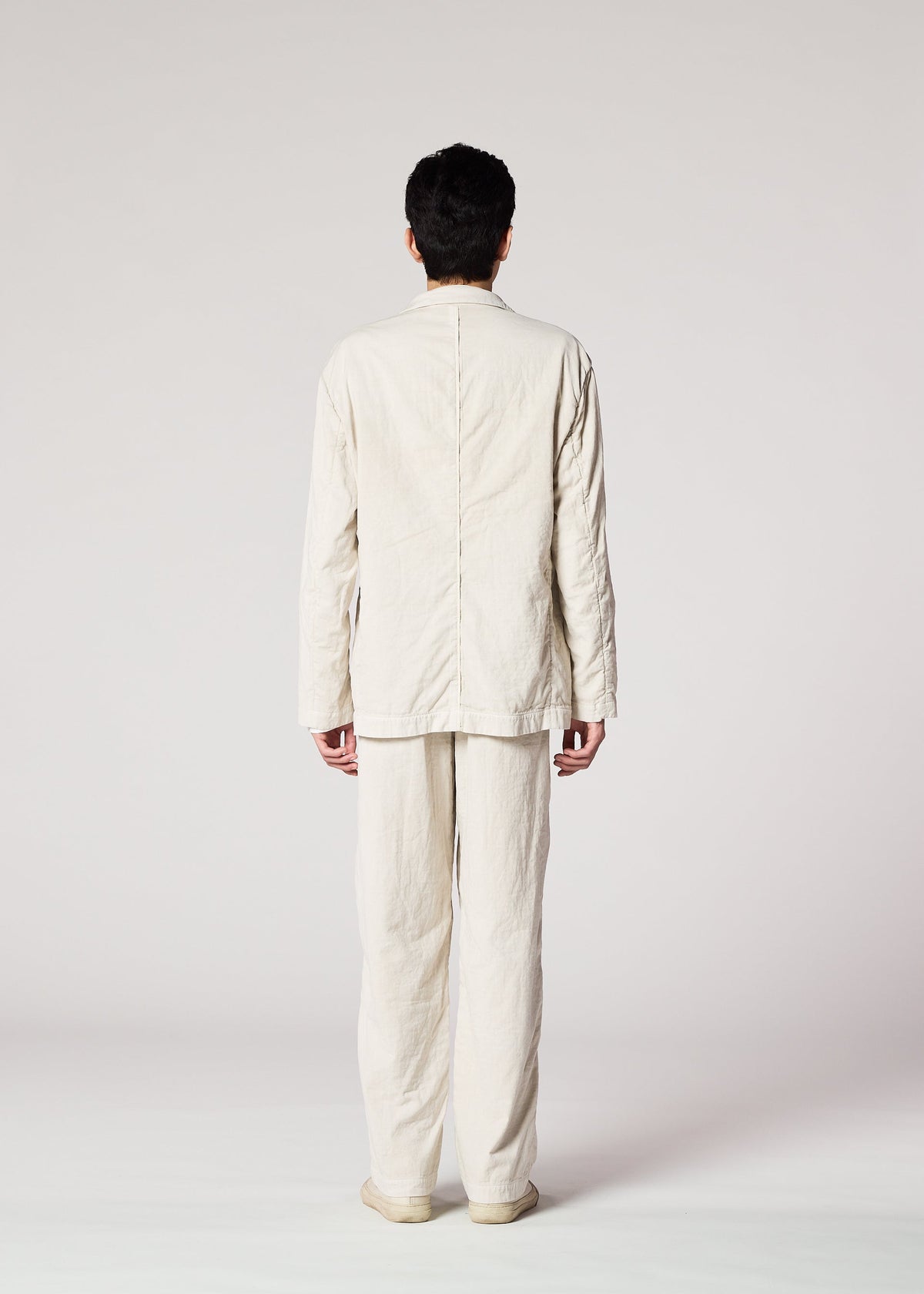 A model wears the IM MEN PIGMENT DOUBLE FACE COTTON trousers.