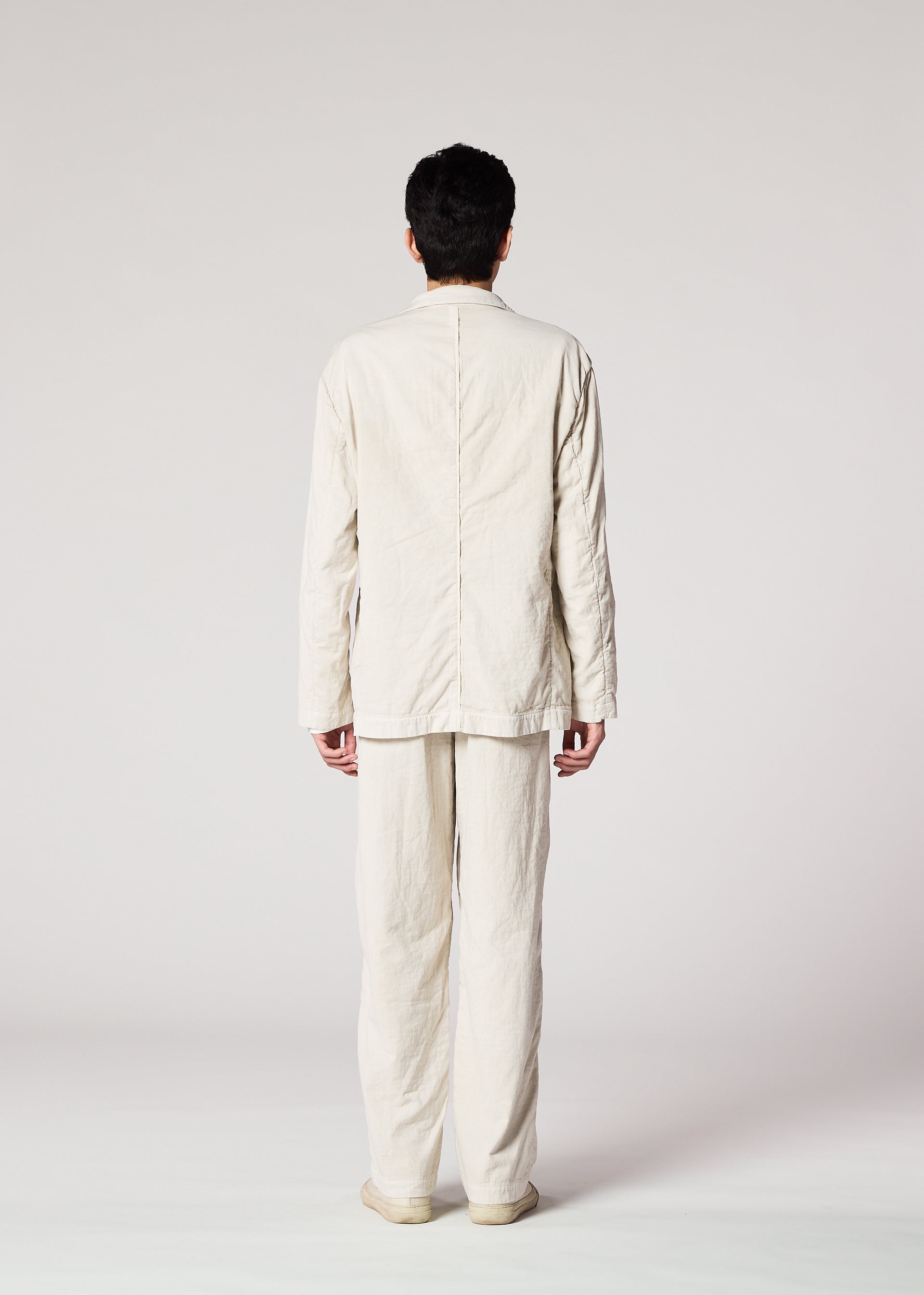 A model wears the IM MEN PIGMENT DOUBLE FACE COTTON trousers.
