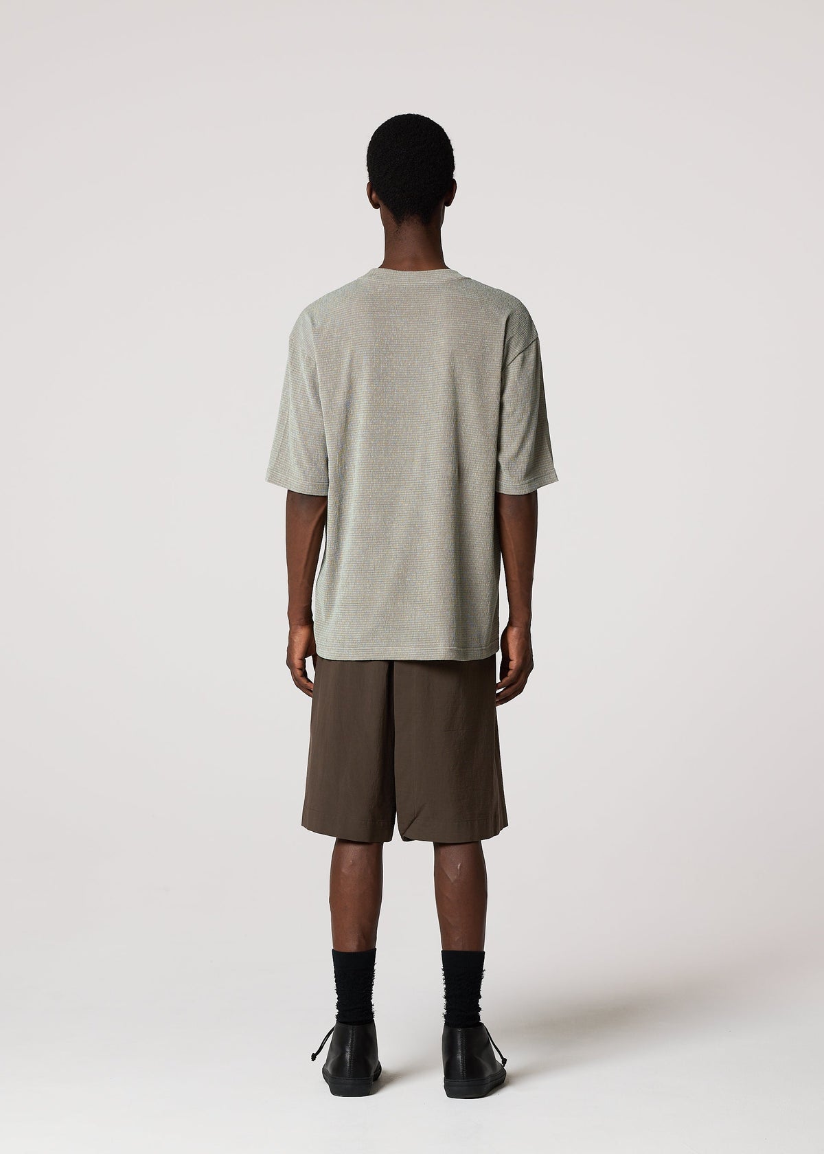A model wears the IM MEN NAVY BOTTOMS navy-bottoms-trousers-dark-brown-1.