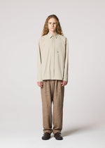 A model wears the IM MEN WHITE SHIRT clothing.