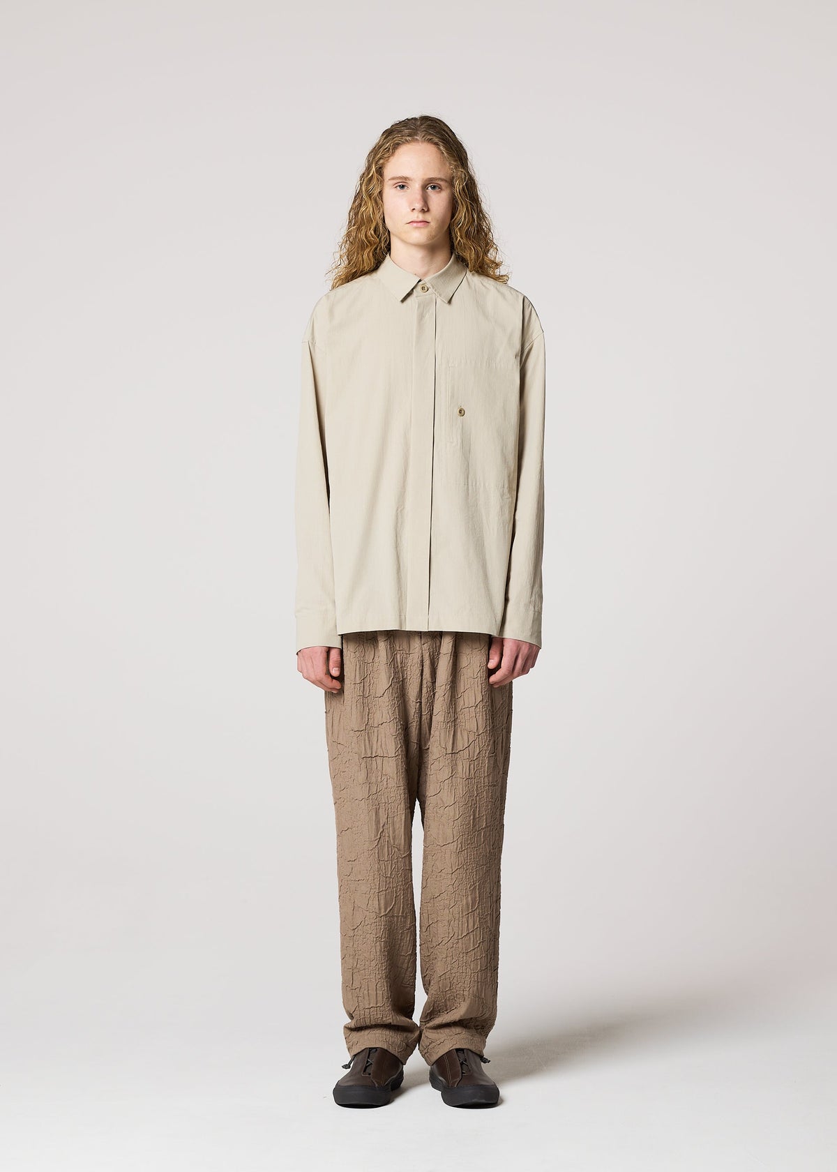 A model wears the IM MEN WHITE SHIRT clothing.
