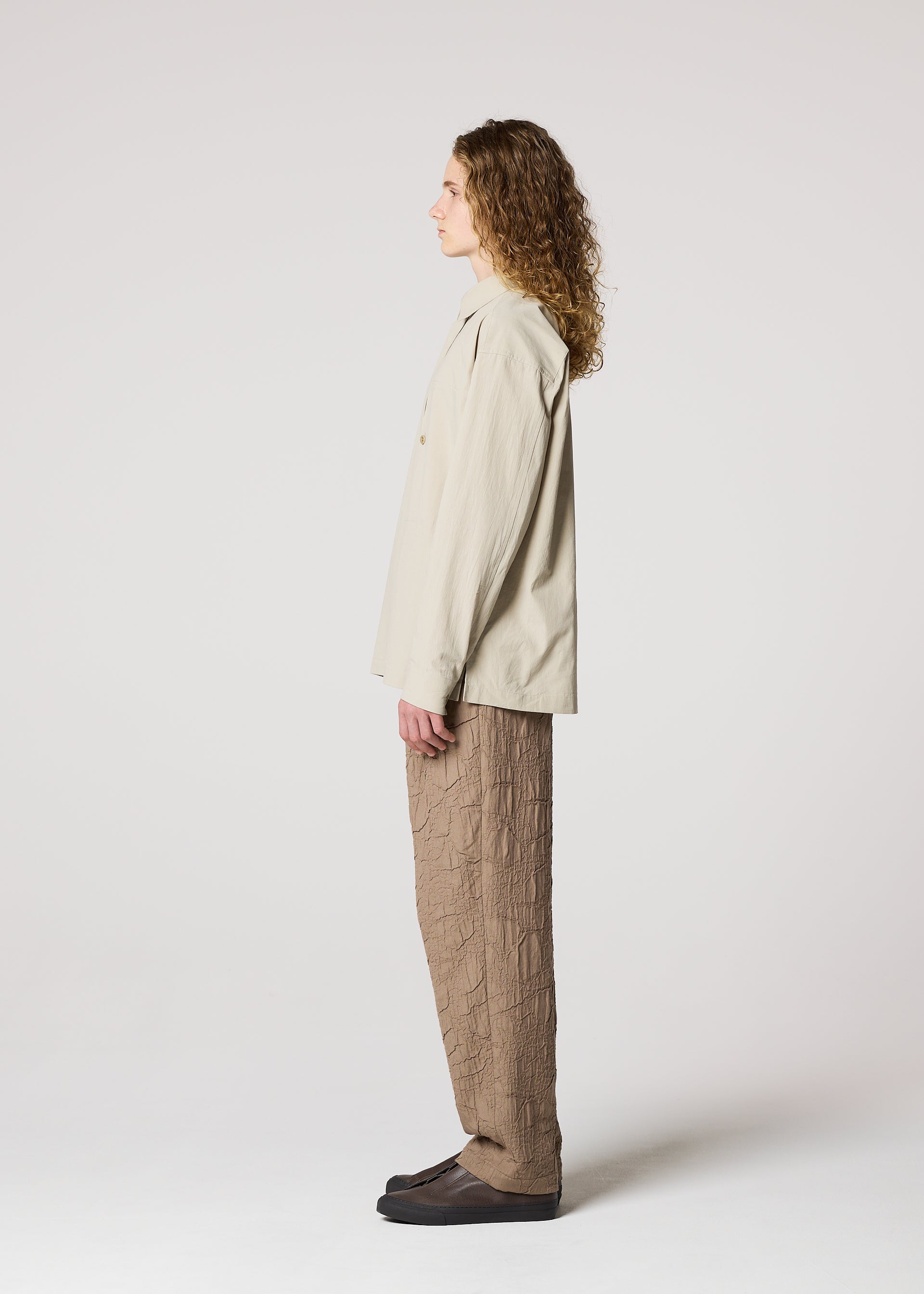 A model wears the IM MEN WHITE SHIRT clothing.