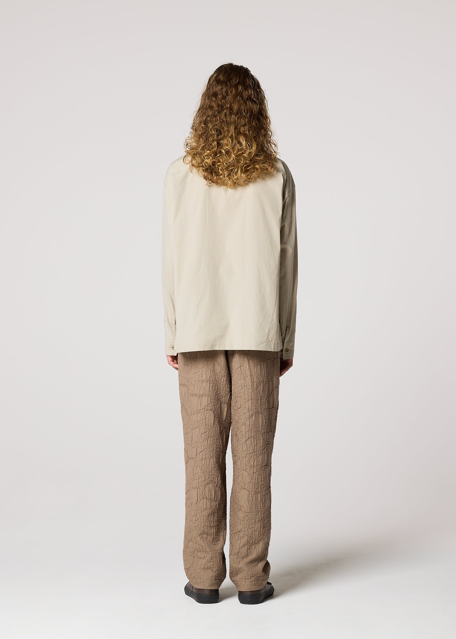 A model wears the IM MEN WHITE SHIRT clothing.