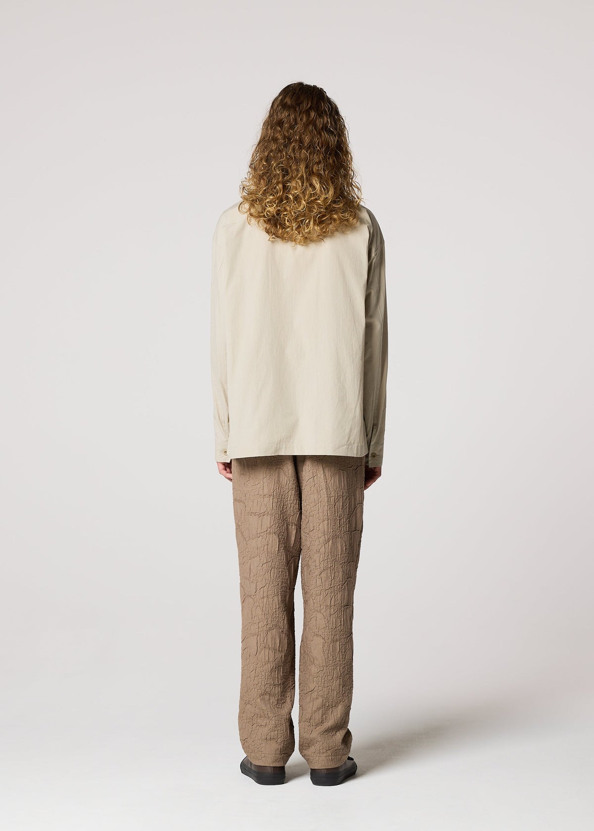 A model wears the IM MEN WHITE SHIRT clothing.