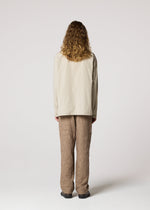 A model wears the IM MEN WHITE SHIRT clothing.
