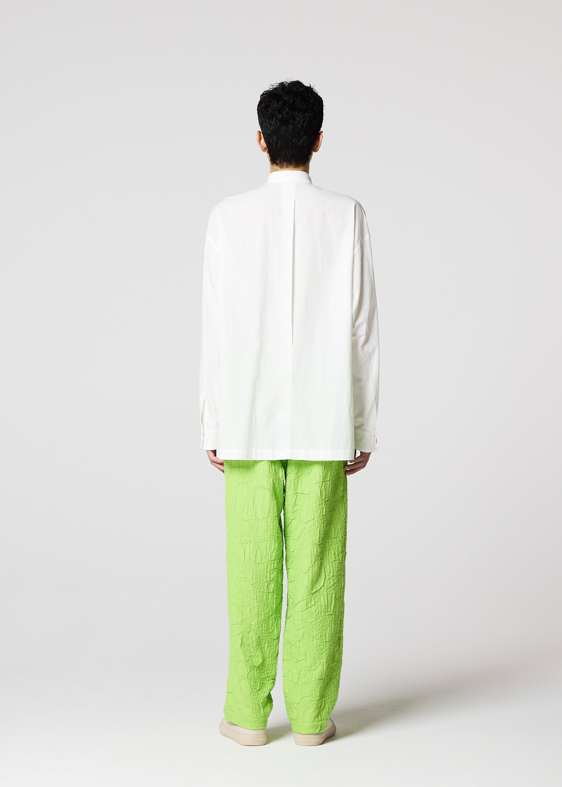 A model wears the IM MEN WHITE SHIRT clothing.