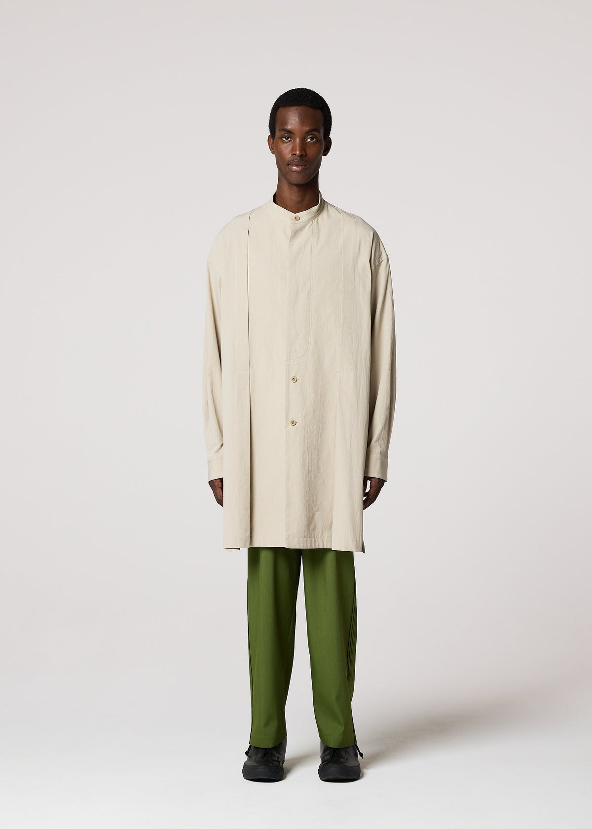 A model wears the IM MEN WHITE SHIRT clothing.