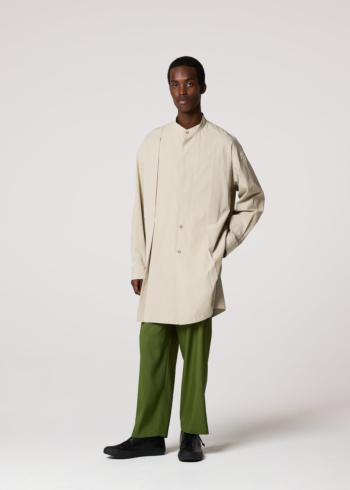 A model wears the IM MEN WHITE SHIRT clothing.