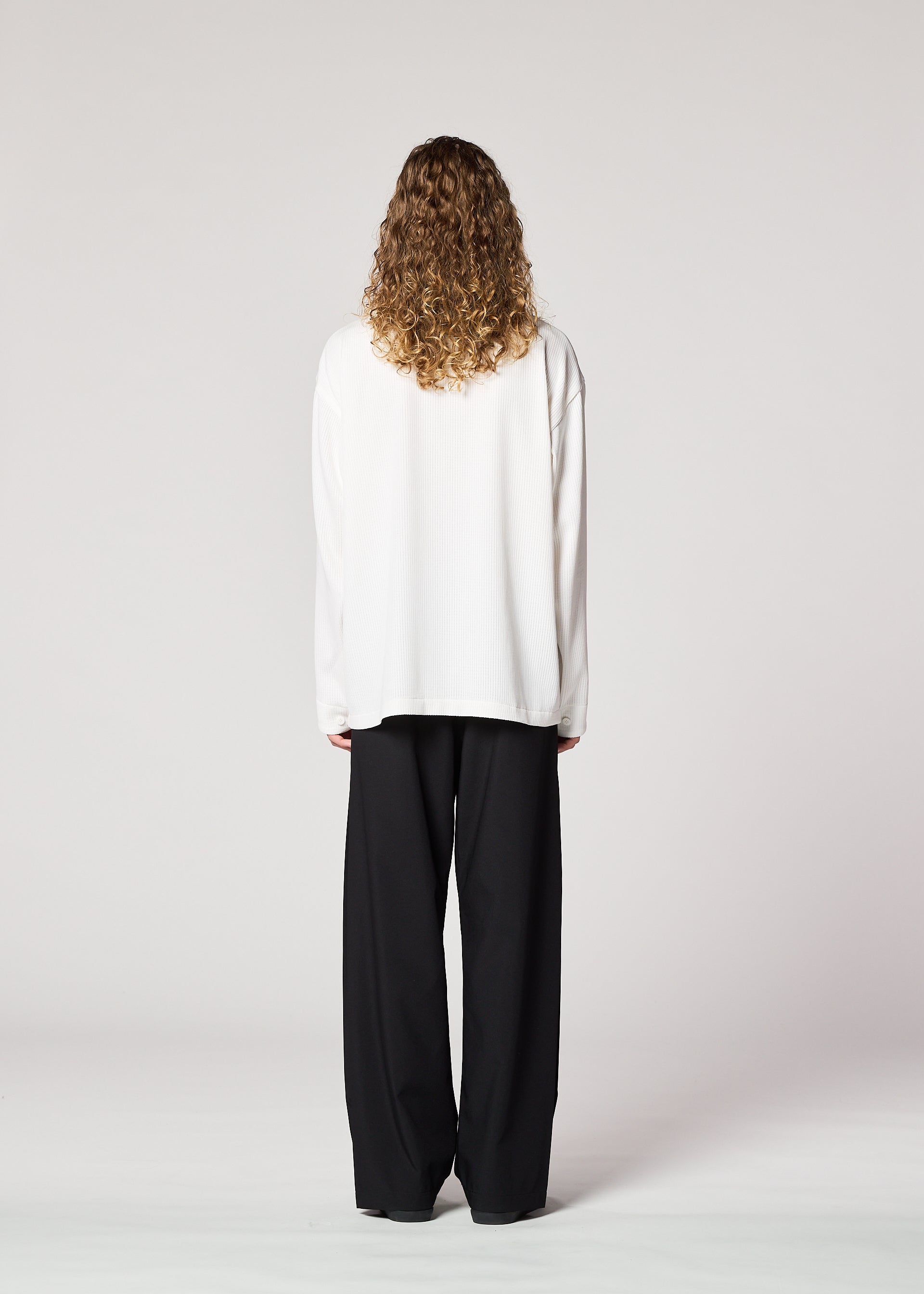 A model wears the IM MEN ONE SIDE TUCK SHIRT shirt.