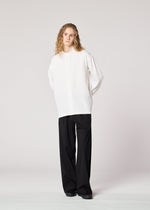 A model wears the IM MEN ONE SIDE TUCK SHIRT shirt.