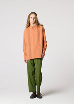A model wears the IM MEN PLEATS SHIRT shirt.