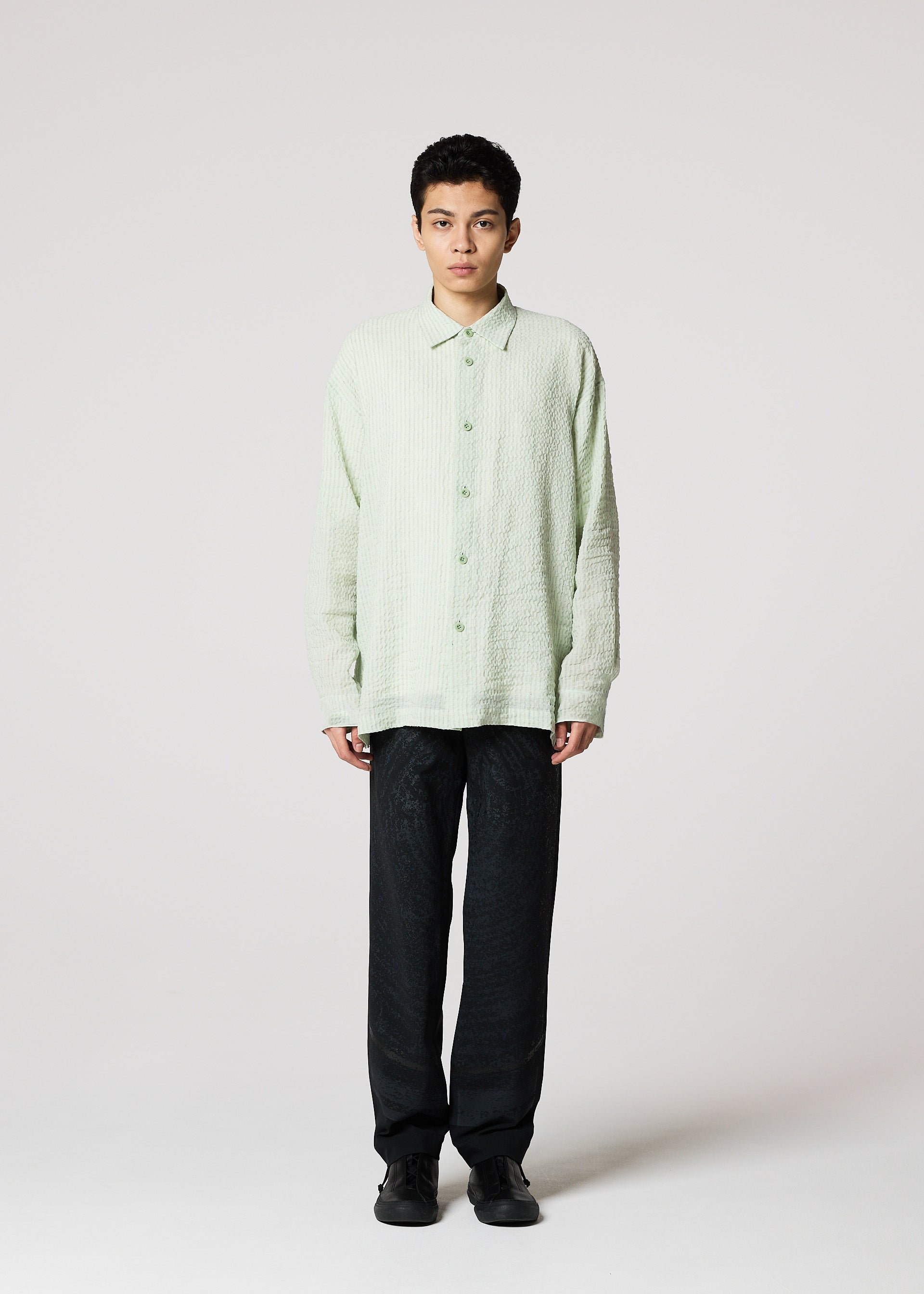 A model wears the IM MEN STRIPE LINEN SHRINK shirt.