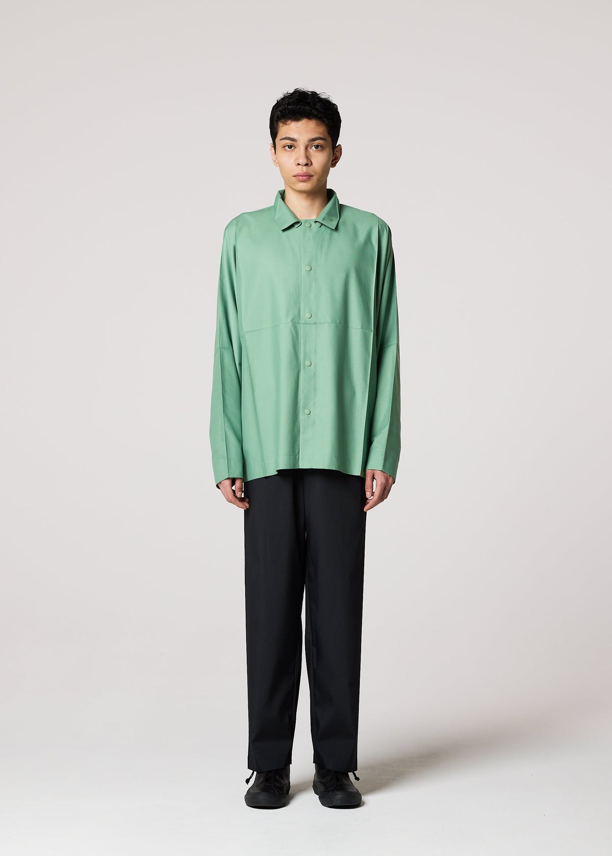 A model wears the IM MEN COMPACT SHIRT shirt.