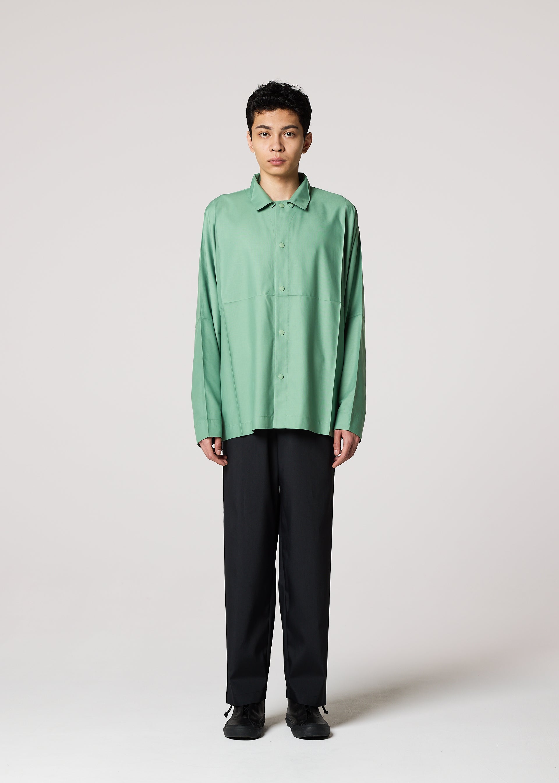 A model wears the IM MEN COMPACT SHIRT shirt.