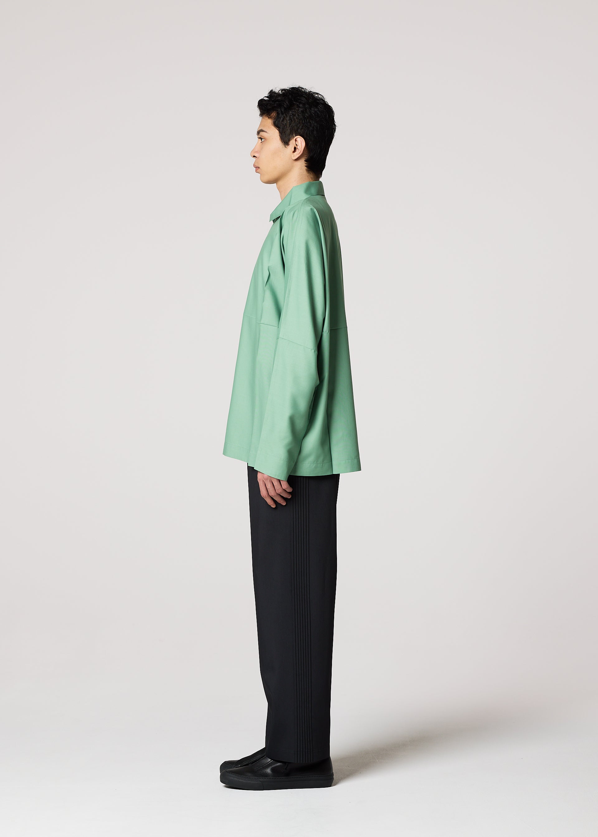 A model wears the IM MEN COMPACT SHIRT shirt.