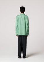 A model wears the IM MEN COMPACT SHIRT shirt.