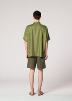 A model wears the IM MEN COMPACT SHIRT shirt.