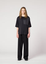 A model wears the IM MEN FLAT T top.