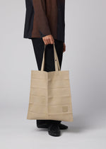 A model wears the IM MEN PATA PA pata-pa-tote-dark-brown.