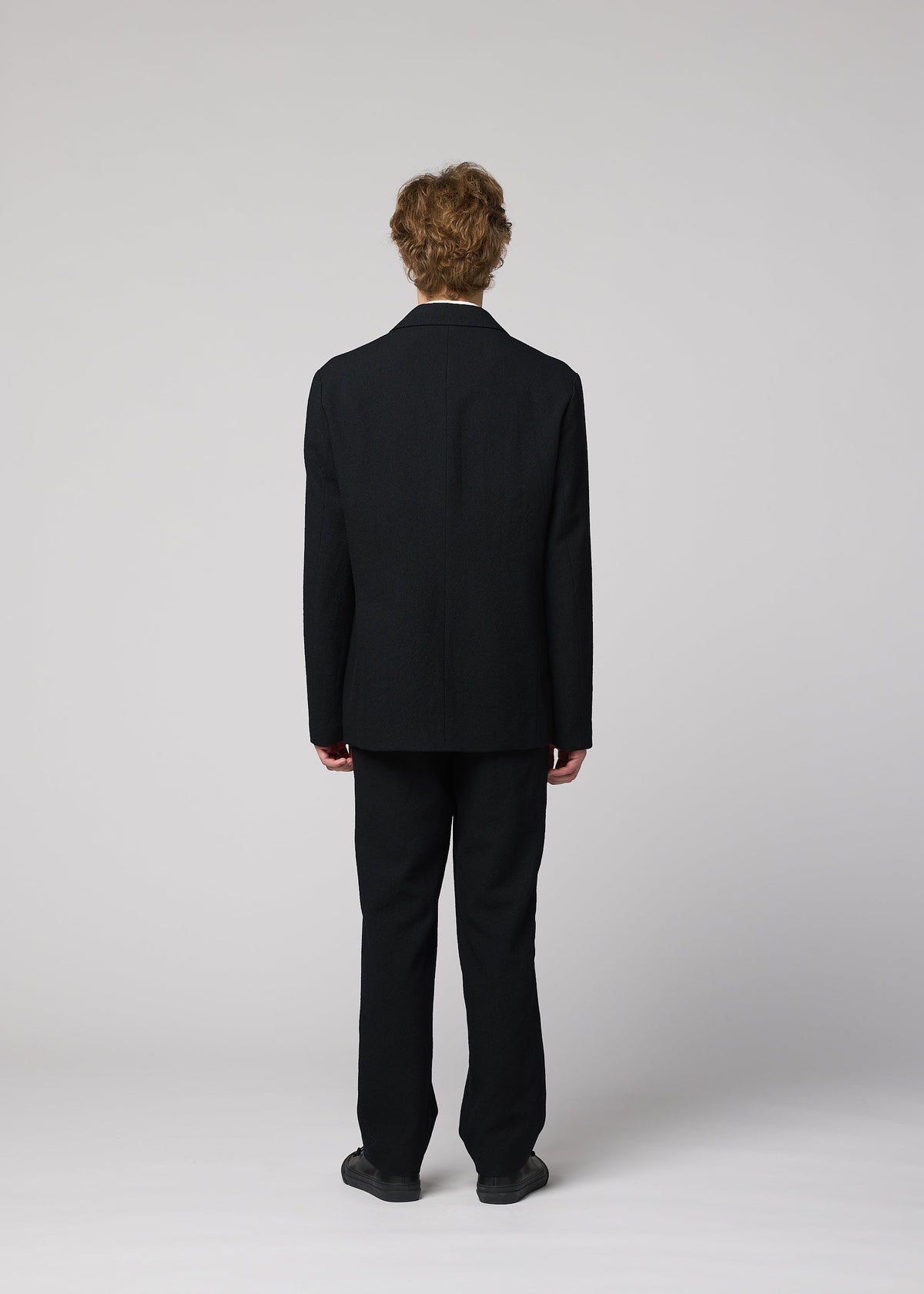 A model wears the IM MEN SHRINK WOOL shrink-wool-single-breasted-jacket-brown.