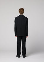 A model wears the IM MEN SHRINK WOOL shrink-wool-single-breasted-jacket-brown.