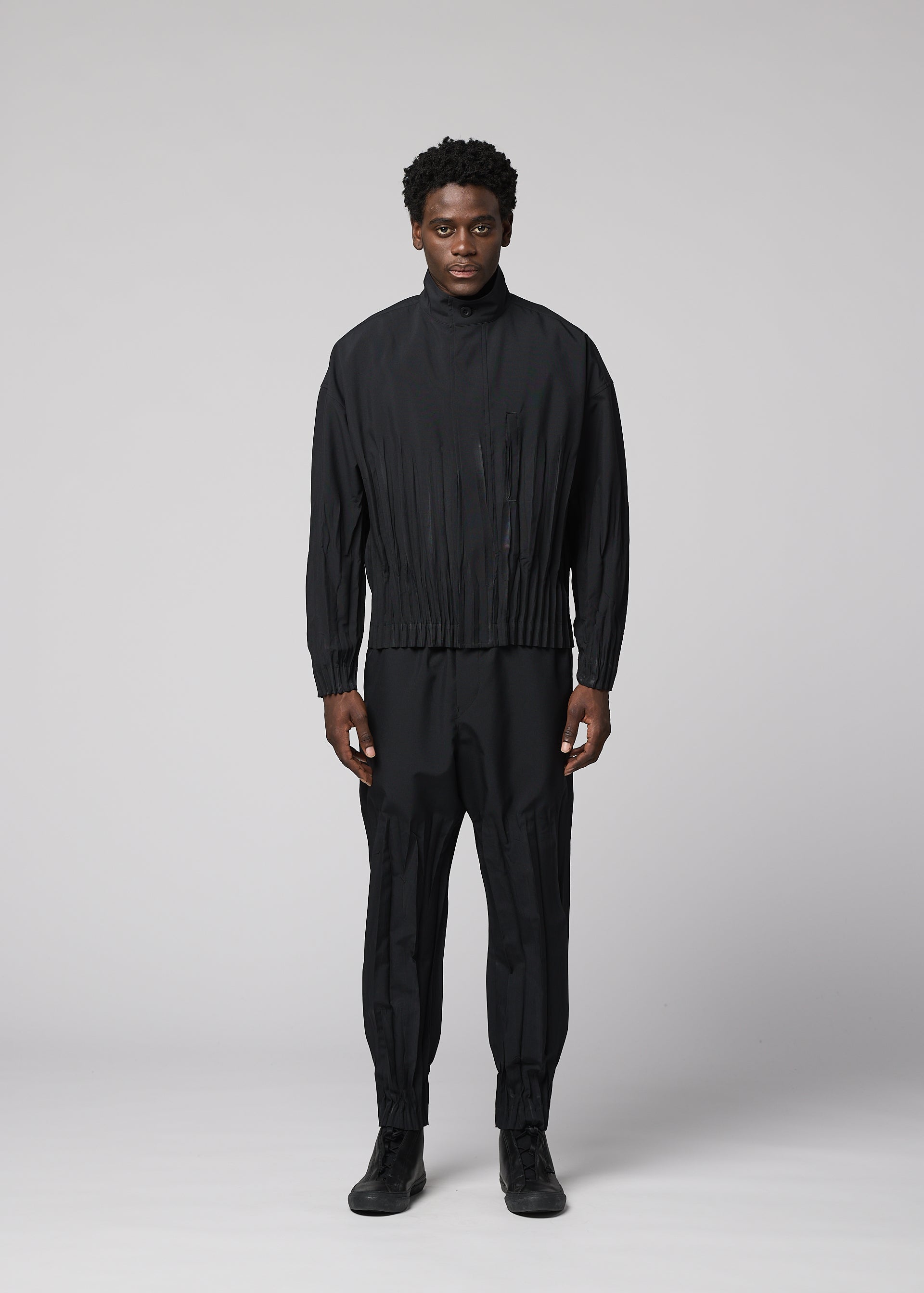 A model wears the IM MEN WAFT BLACK waft-black-trousers-black-1.