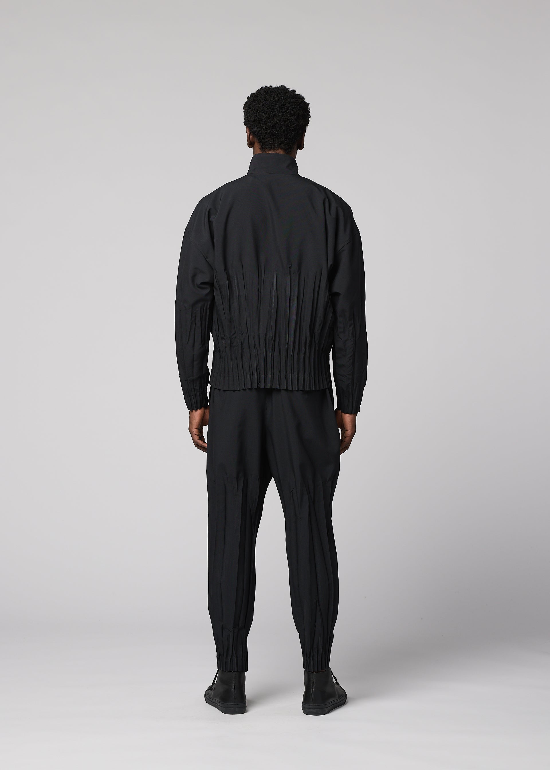 A model wears the IM MEN WAFT BLACK waft-black-trousers-black-1.