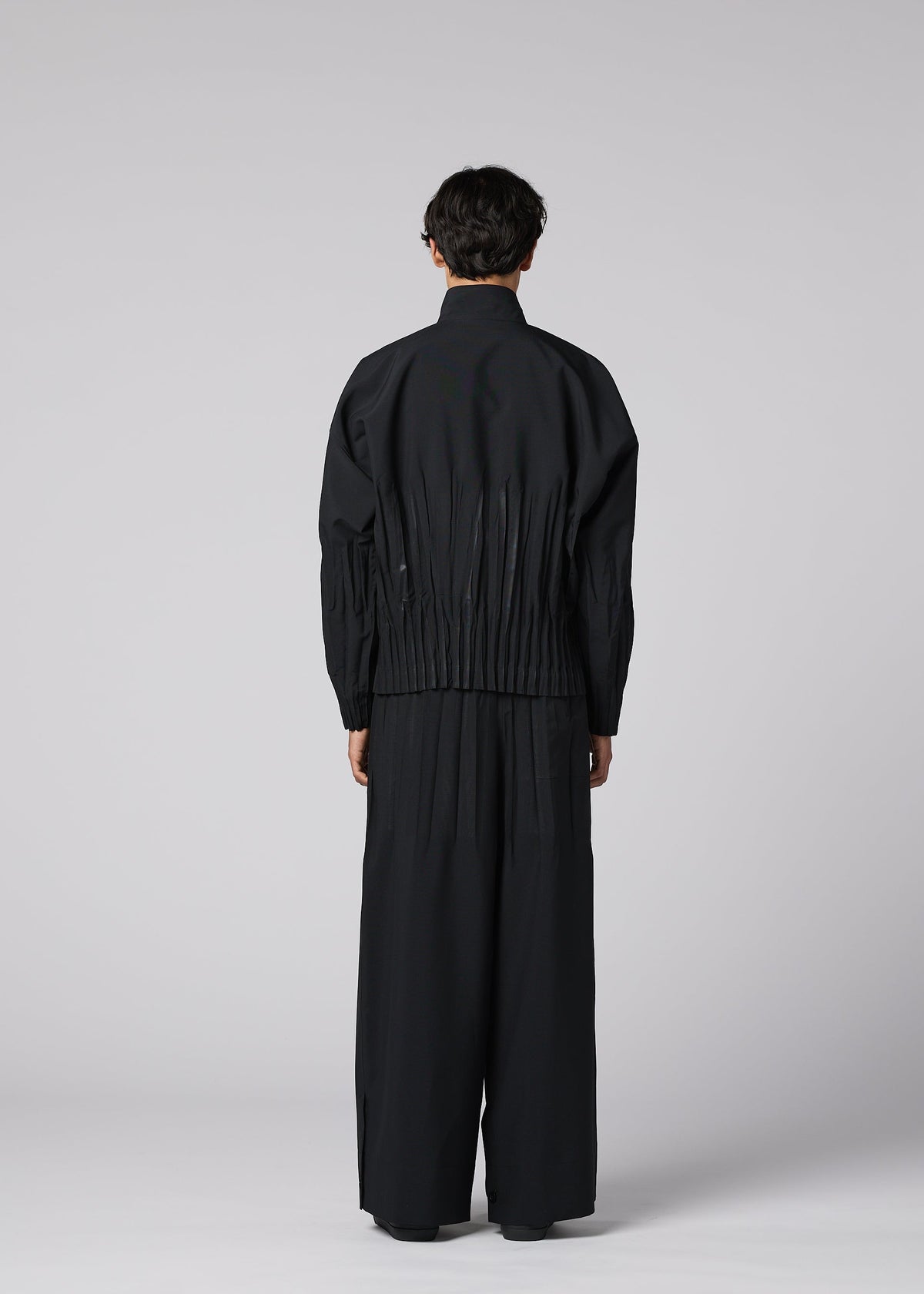 A model wears the IM MEN WAFT BLACK waft-black-trousers-black-2.