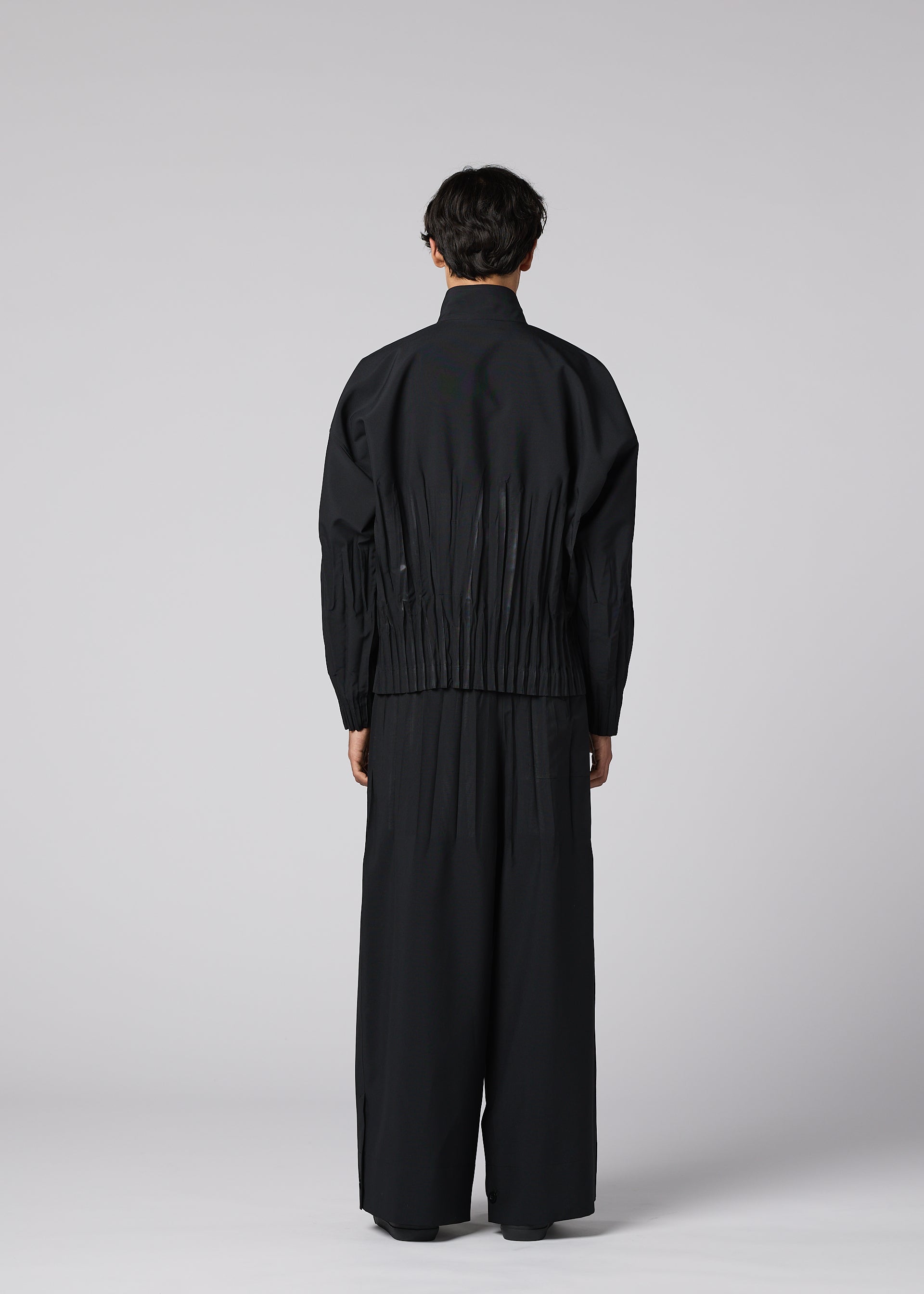 A model wears the IM MEN WAFT BLACK waft-black-trousers-black-2.