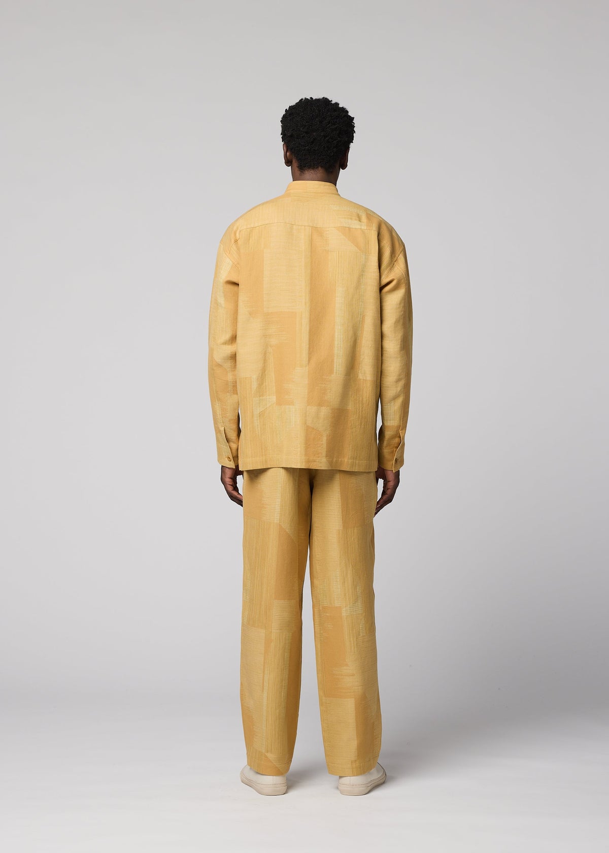 A model wears the IM MEN KASURI kasuri-straight-leg-trousers-black.