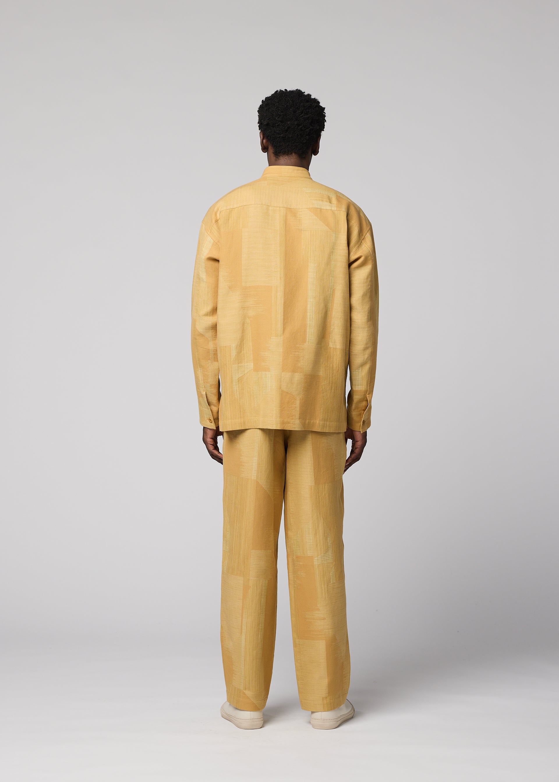 A model wears the IM MEN KASURI kasuri-straight-leg-trousers-black.