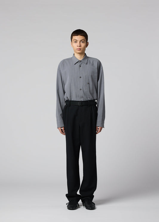 A model wears the IM MEN SHRINK WOOL shrink-wool-tapered-trousers-brown.