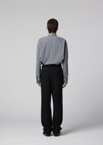 A model wears the IM MEN SHRINK WOOL shrink-wool-tapered-trousers-black.