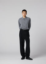 A model wears the IM MEN SHRINK WOOL shrink-wool-tapered-trousers-black.