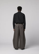 A model wears the IM MEN OVERLAP overlap-trousers-brown.