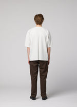 A model wears the IM MEN FLAT T top.