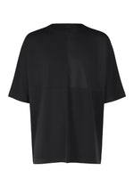 A product shot of the IM MEN FLAT T top in black.