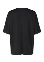 A detail shot of the IM MEN FLAT T top.