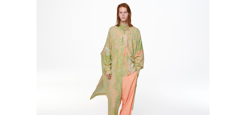 Centre: Model wearing BY CHANCE Shirt and Long Shirt in Light Green, left hand in pocket, in a relaxed pose against a white background.