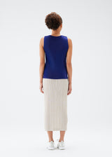 A model wears the PLEATS PLEASE ISSEY MIYAKE  MIST JULY top