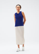 A model wears the PLEATS PLEASE ISSEY MIYAKE  MIST JULY top