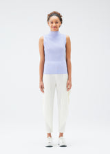 A model wears the PLEATS PLEASE ISSEY MIYAKE  MIST JULY top