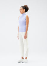 A model wears the PLEATS PLEASE ISSEY MIYAKE  MIST JULY top