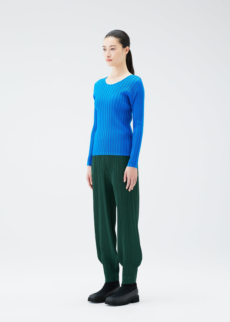 A model wears the PLEATS PLEASE ISSEY MIYAKE RIB PLEATS OCTOBER top.