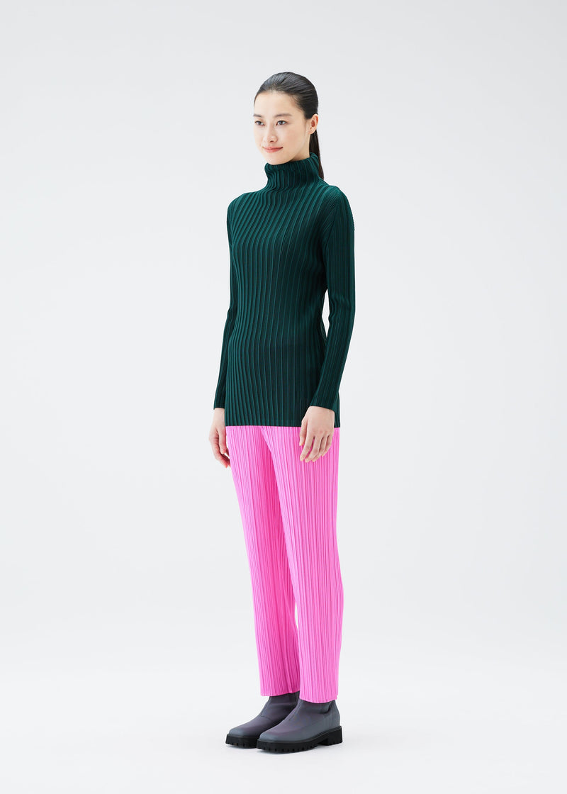 A model wears the PLEATS PLEASE ISSEY MIYAKE RIB PLEATS OCTOBER top.